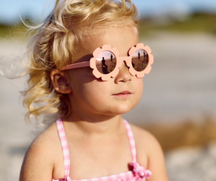 little girl wearing flower sunglasses