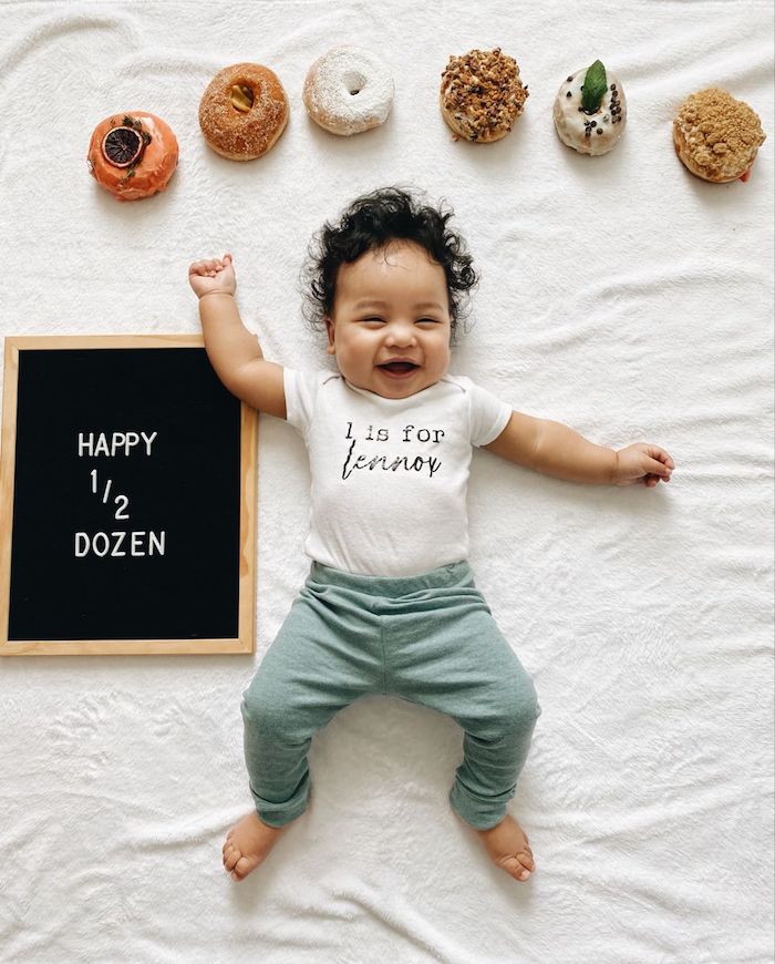 6 month baby photo showing baby with doughnuts