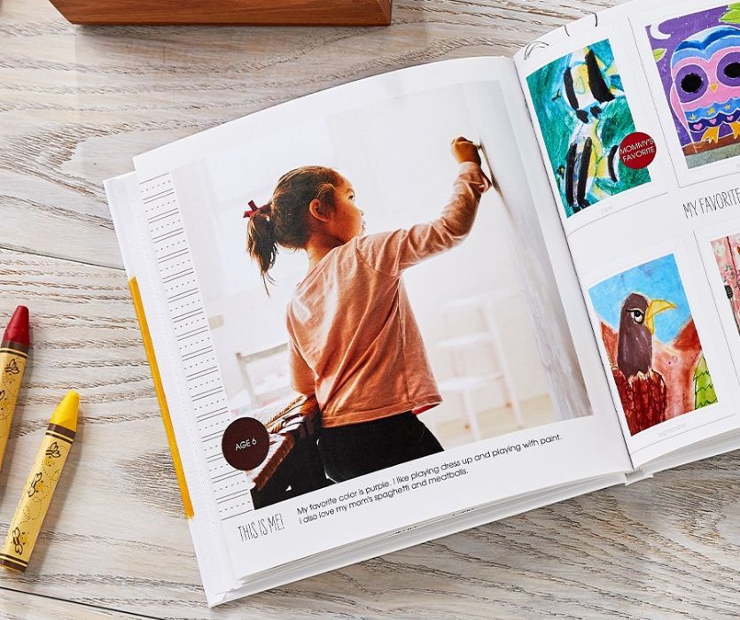 shutterfly custom album open with picture of girl drawing