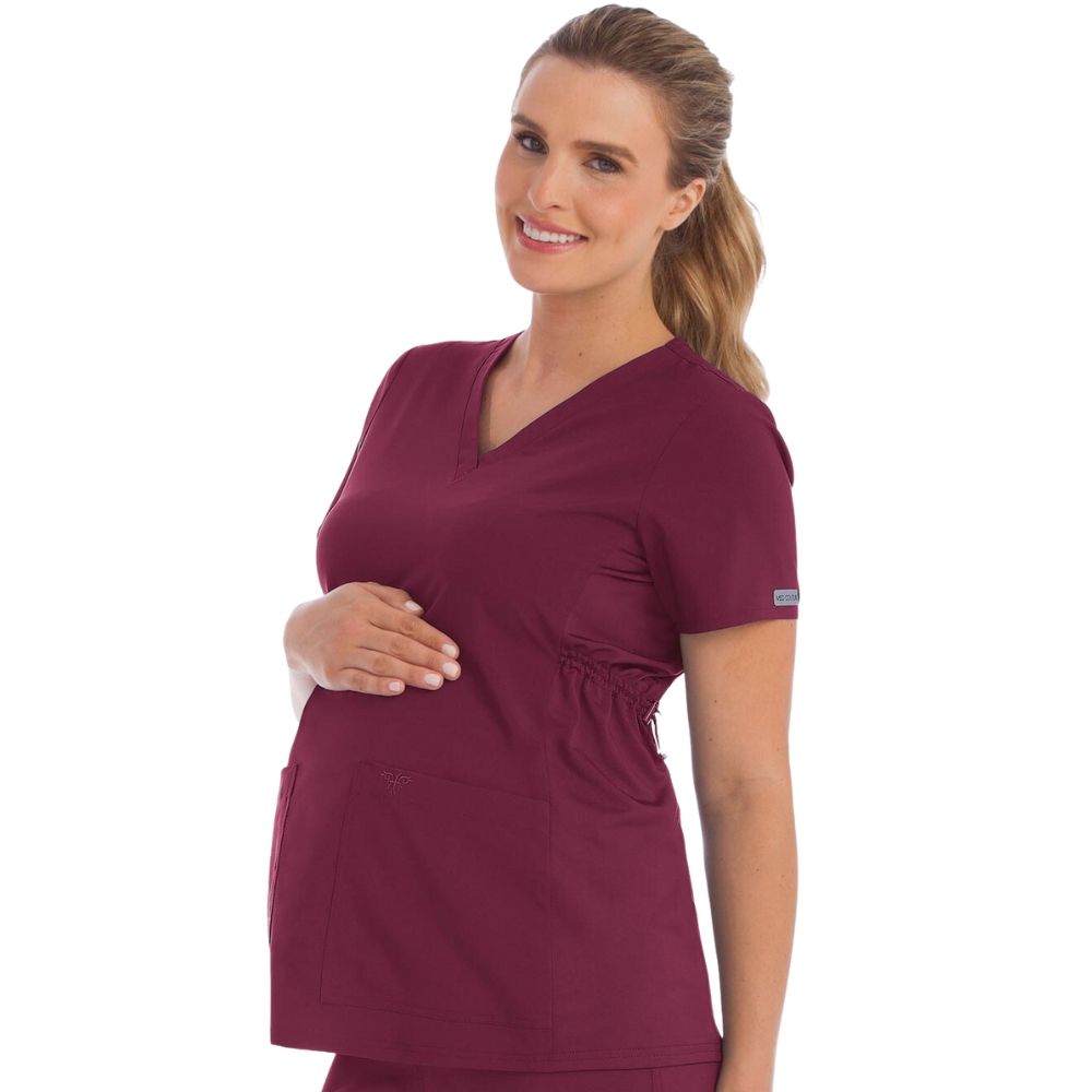 woman wearing wine colored scrubs during her pregnancy