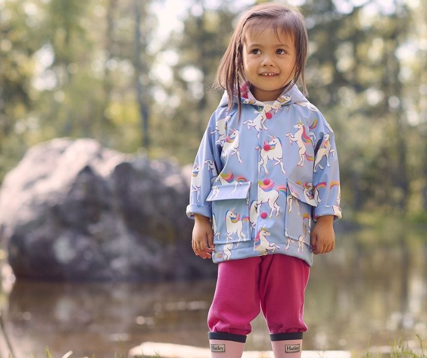 little girl wearing hatley raincoat and boots