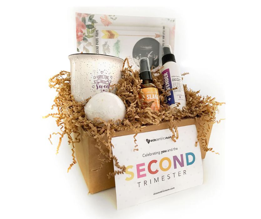 Ecocentric Mom Pregnancy Subscription Box selection showing a variety of samples including bath bomb, mug, etc.