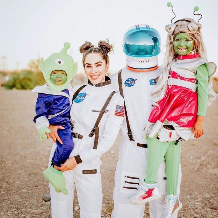 mom and dad dressed as astronauts with martian kids