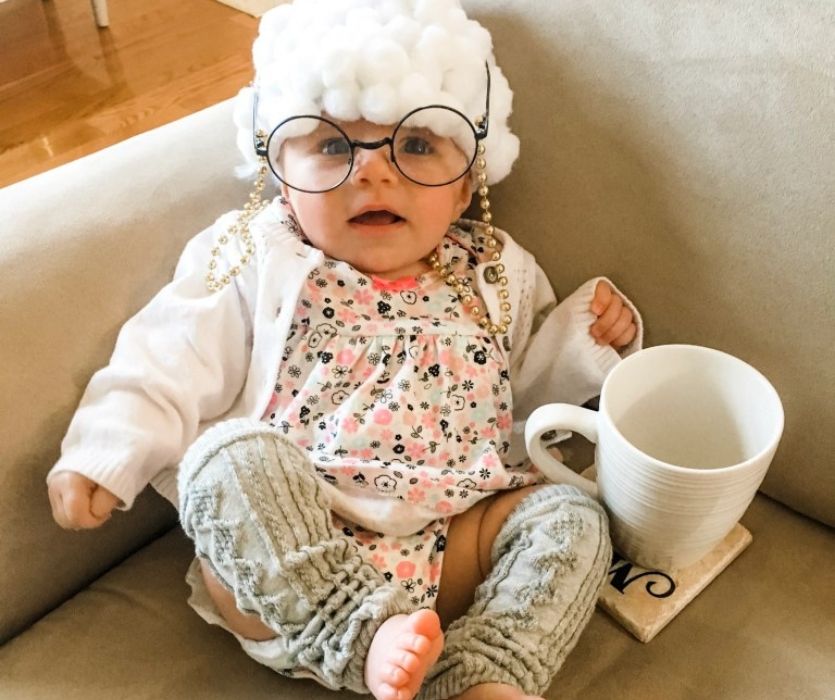 baby dressed as an old woman