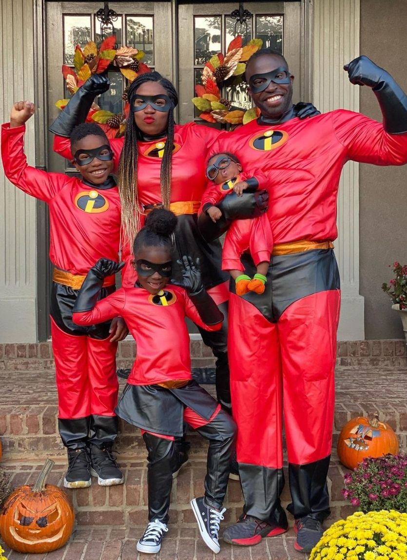 family with newborn baby dressed as the incredibles