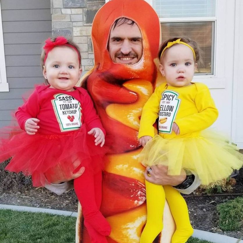 dad dressed as a hotdog with toddlers wearing mustard and ketchup
