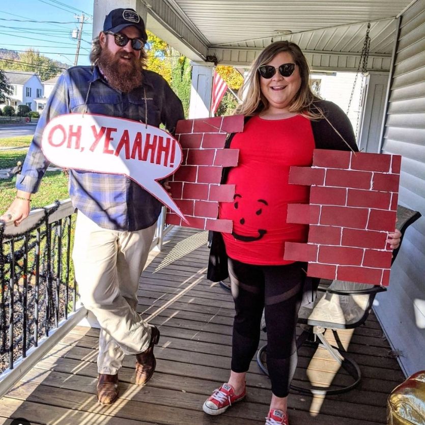 couple wearing Kool-Aid Man and Wall pregnancy halloween costumes