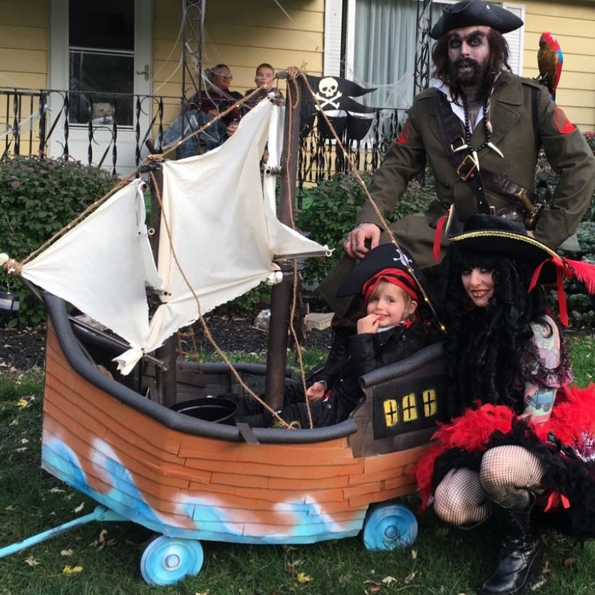 toddler sitting in a wagon made to look like a pirate ship