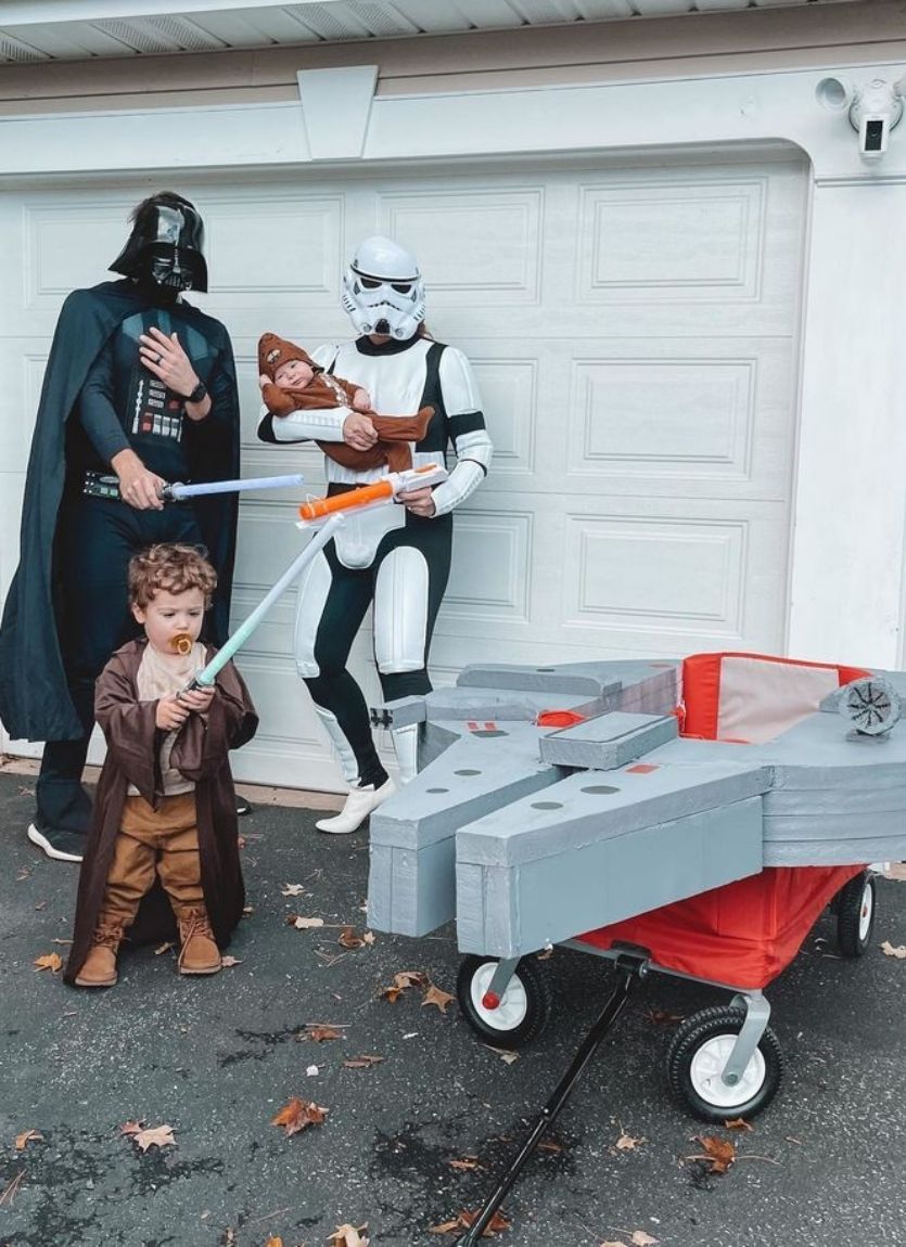 family dressed as star wars characters with Millennium Falcon wagon
