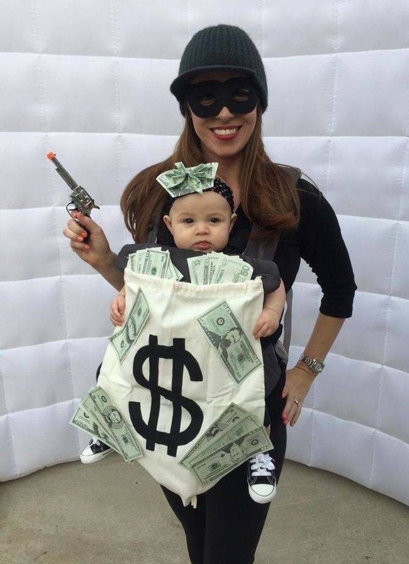 mom dressed as a bank robber with baby dressed as a bag of money