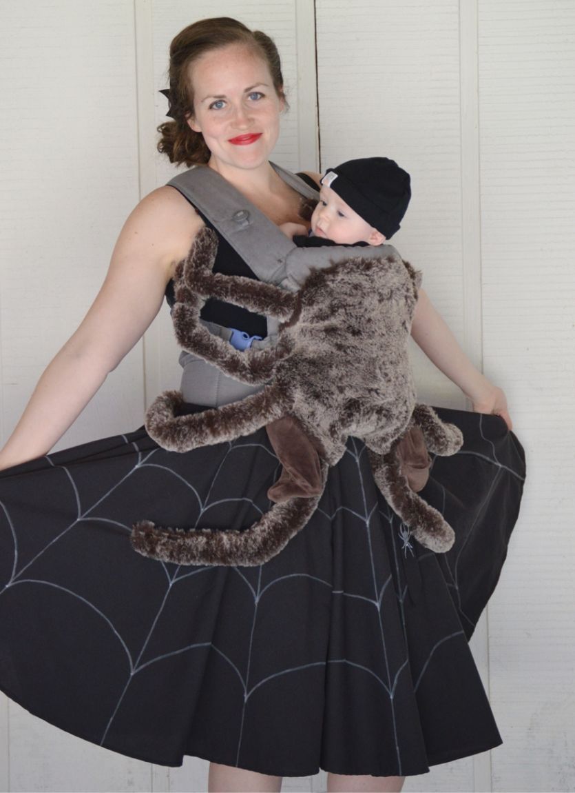 mother and baby in a carrier dressed as a spider in a spider web