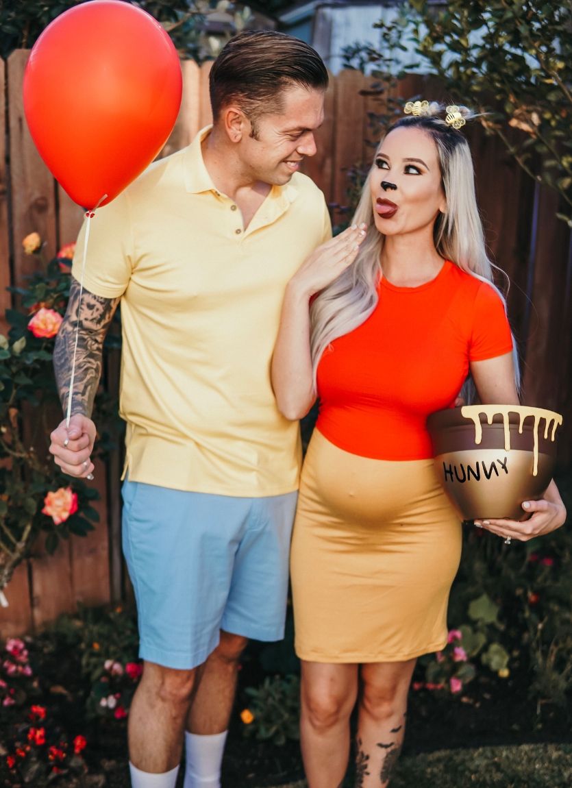 couple dressed as pregnant Winnie the Pooh and Christopher Robin