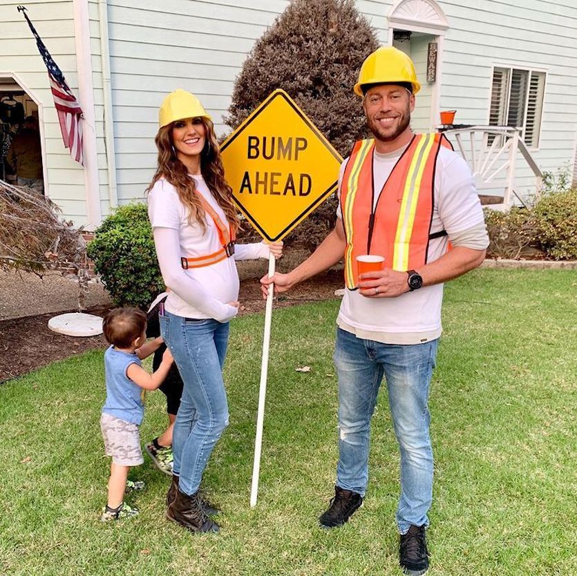 pregnancy couples costume with bump ahead sign
