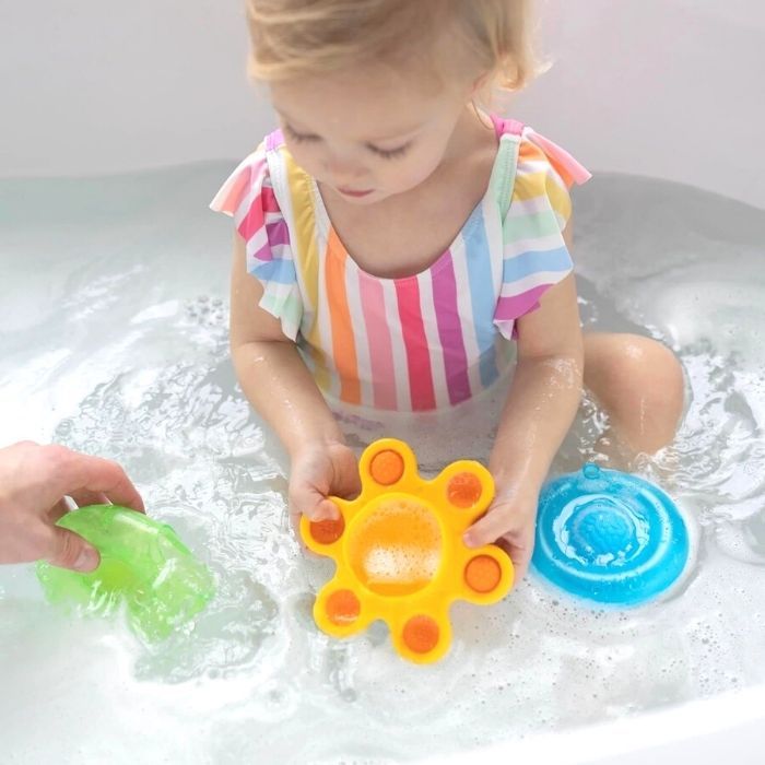 baby in tub with Fat Brain Toys Dimpl Splash Bath Toys