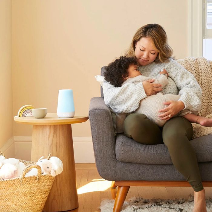 mom holds the baby in an apartment with a hatch rest on the table