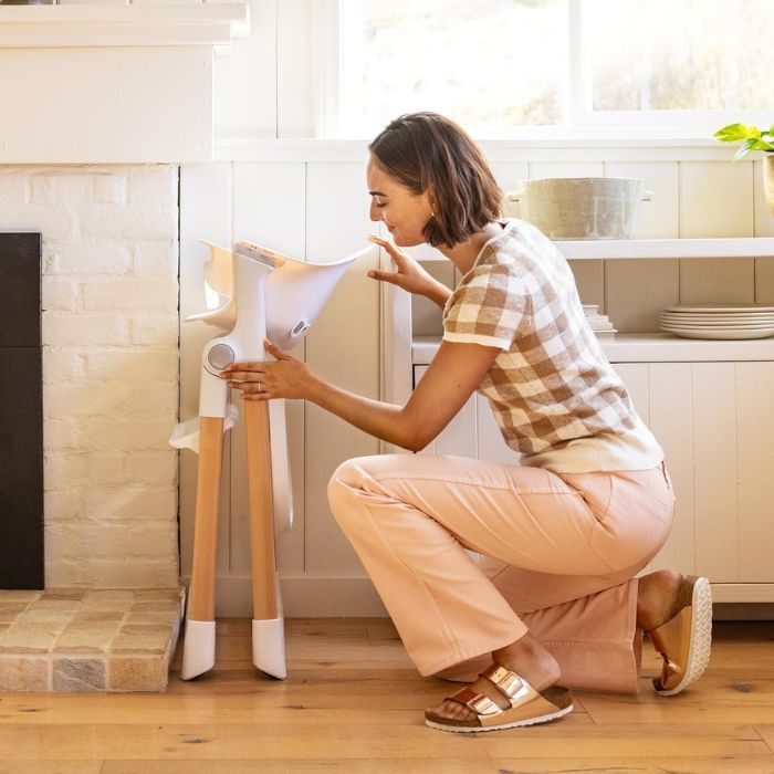 mom puts a Foldable High Chair in a small corner