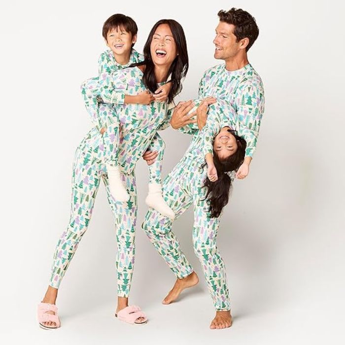 parents with two kids wearing christmas tree pajamas from Amazon