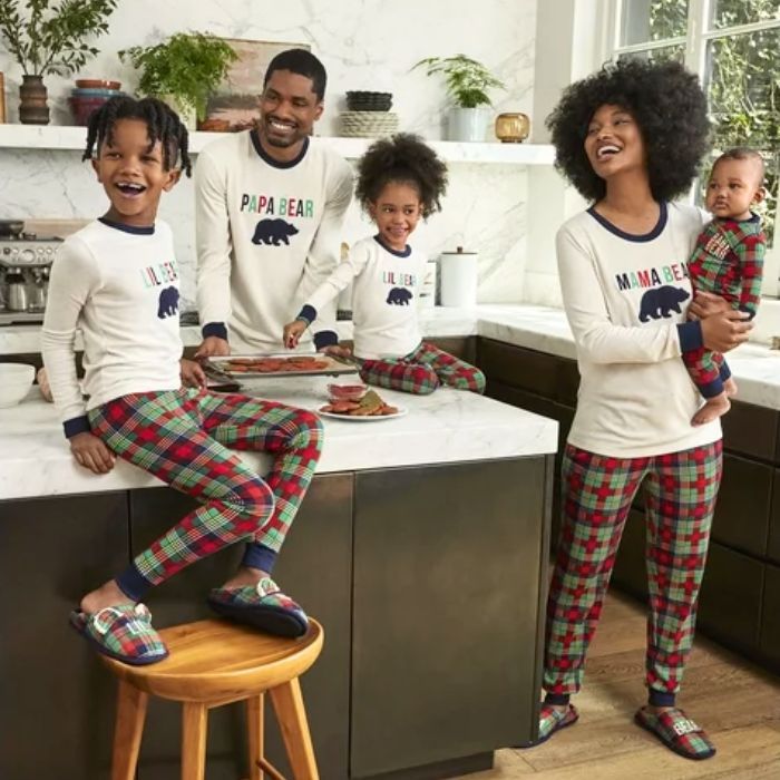 family in kitchen wearing plaid holiday sleepwear