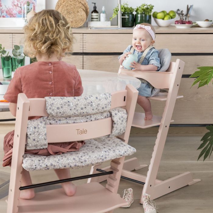 baby and toddler sitting in pink custom stokke highchairs