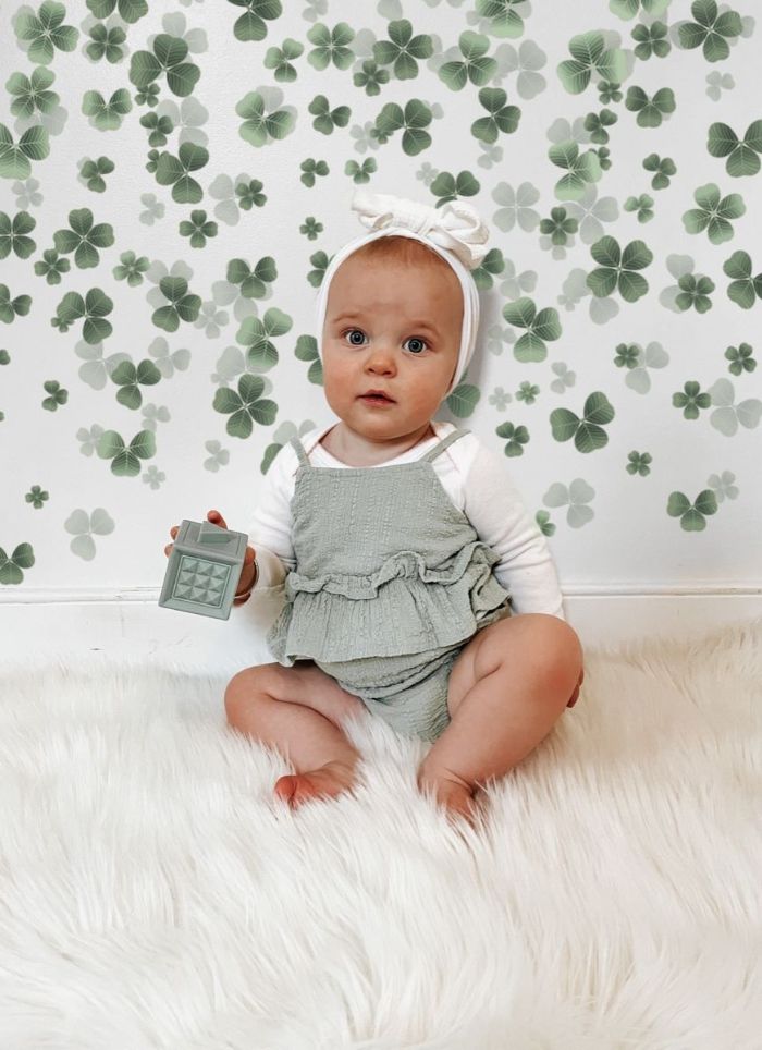 Green outfit clovers background baby St. Patrick's Day photo