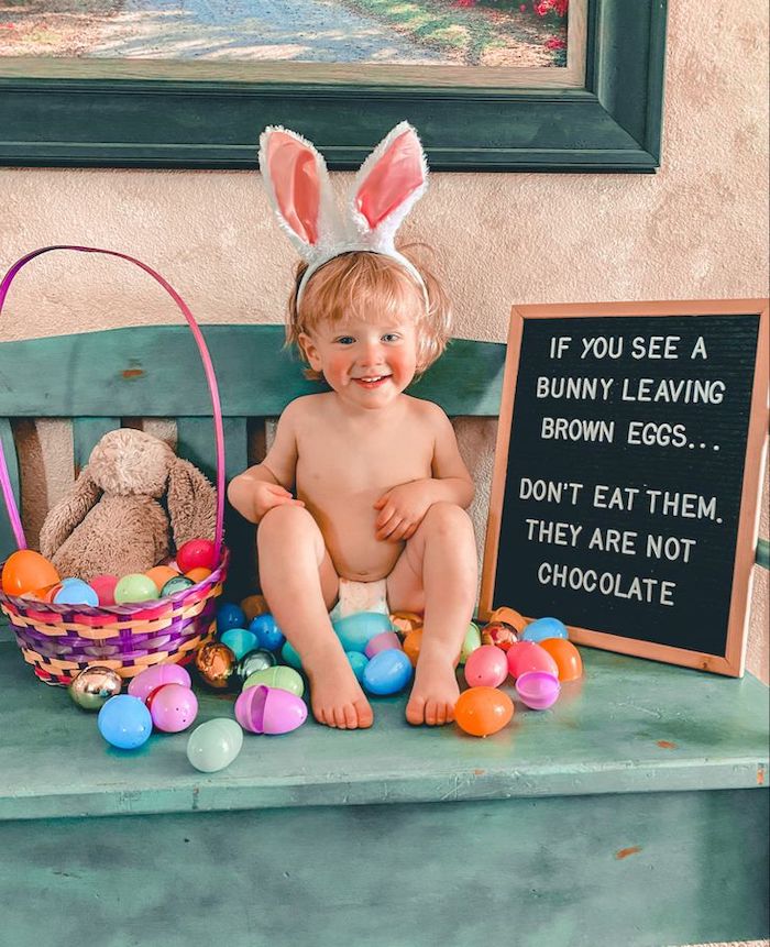 Baby's Easter photo funny whiteboard idea with stuffed bunny and eggs in basket