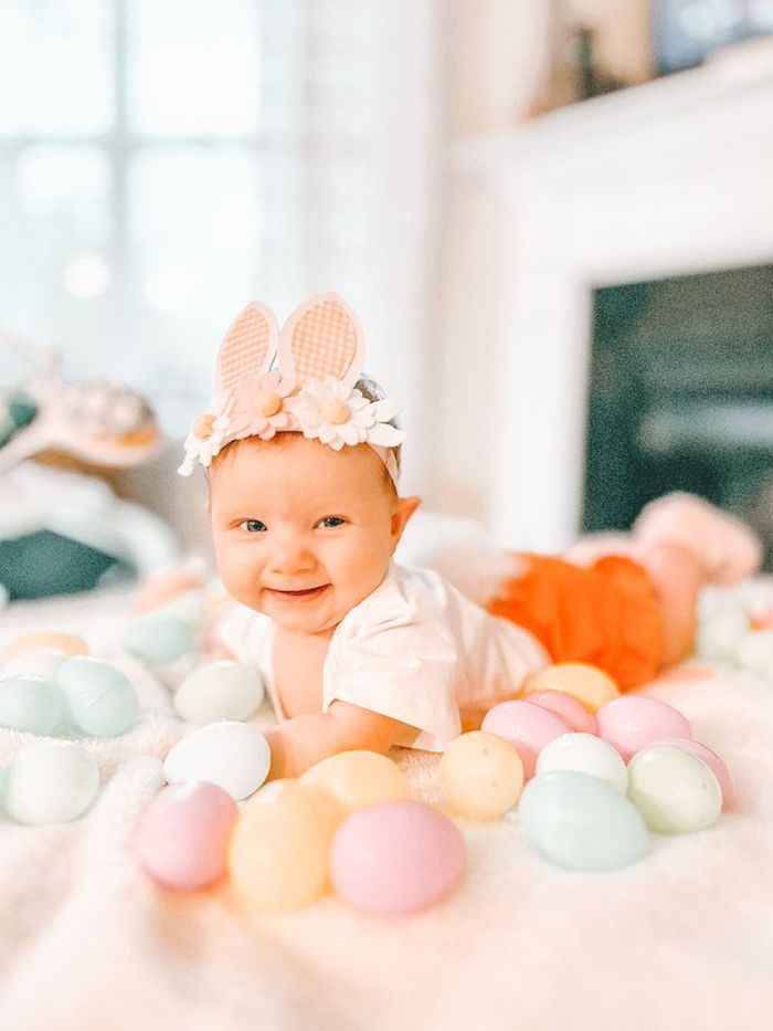 Baby's First Easter photo with pastel eggs wearing bunny headband