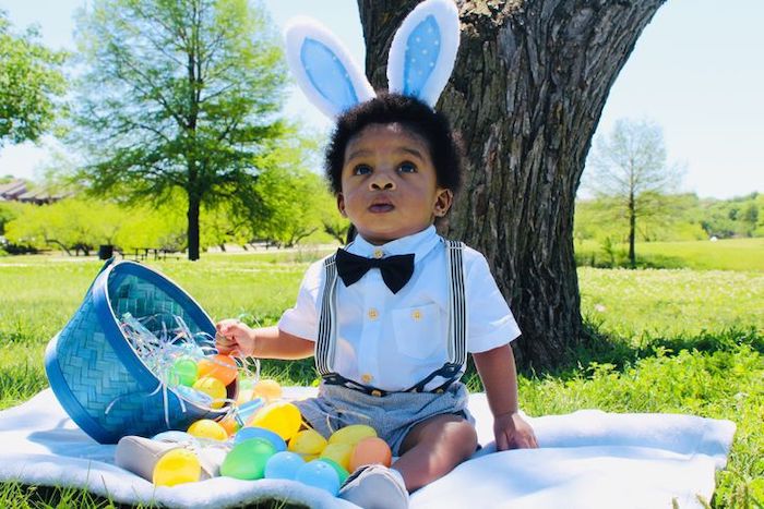 Baby's first easter outdoor photo dressed with with bowtie and bunny ears