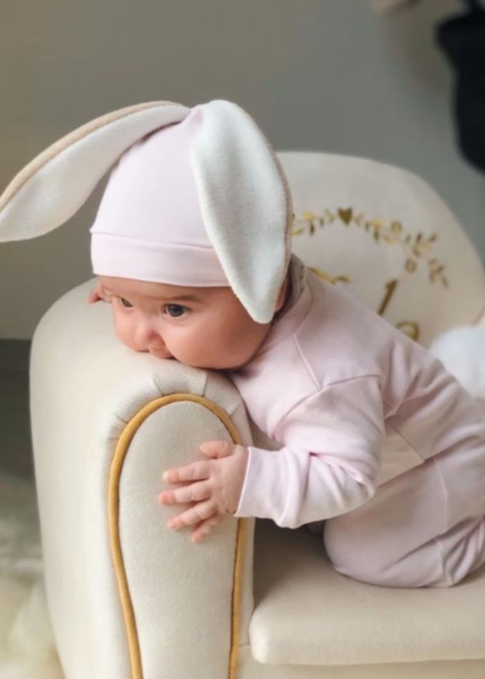 baby wearing pink bunny ears for easter photo