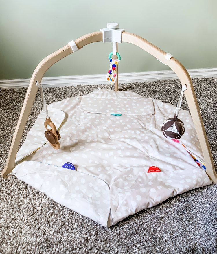 Lovevery play gym mat with zones of play folded in showing how minimalistic it can look.