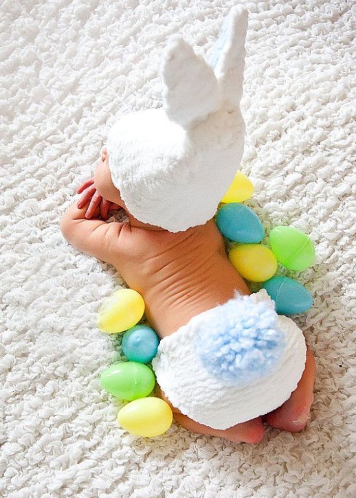 infant wearing bunny hat and diaper cover with blue tail