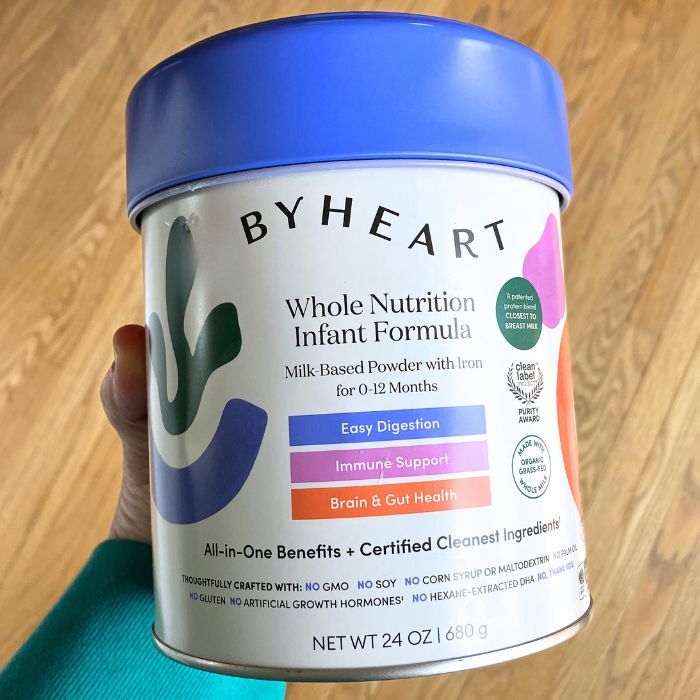 mom holding byheart baby formula can