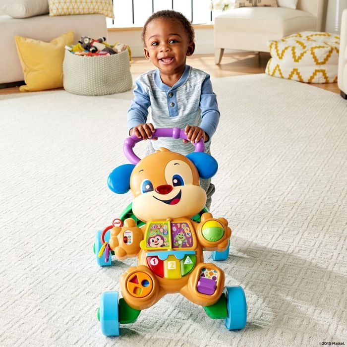 toddler playing with fisher price walker