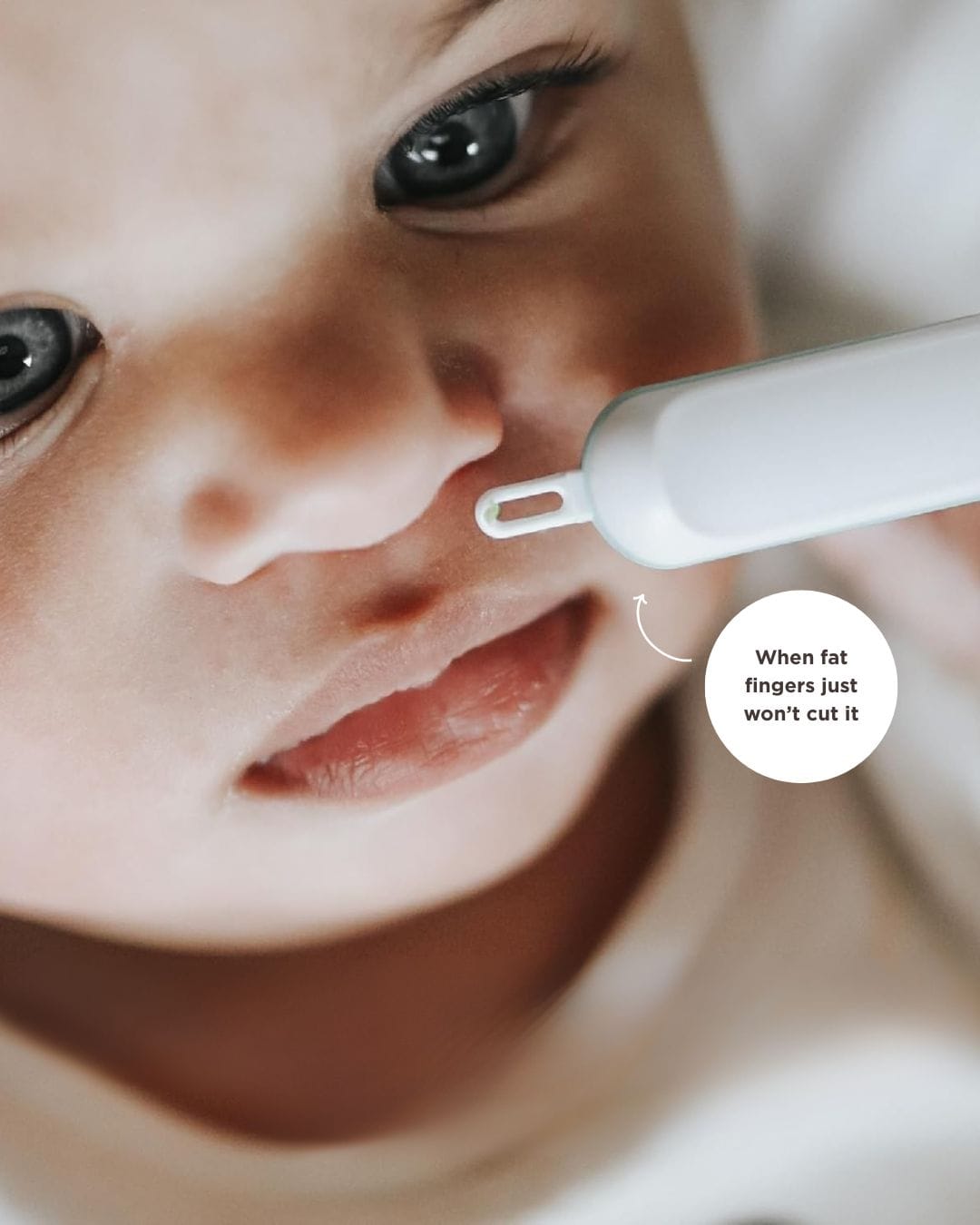 baby with nose picker tool