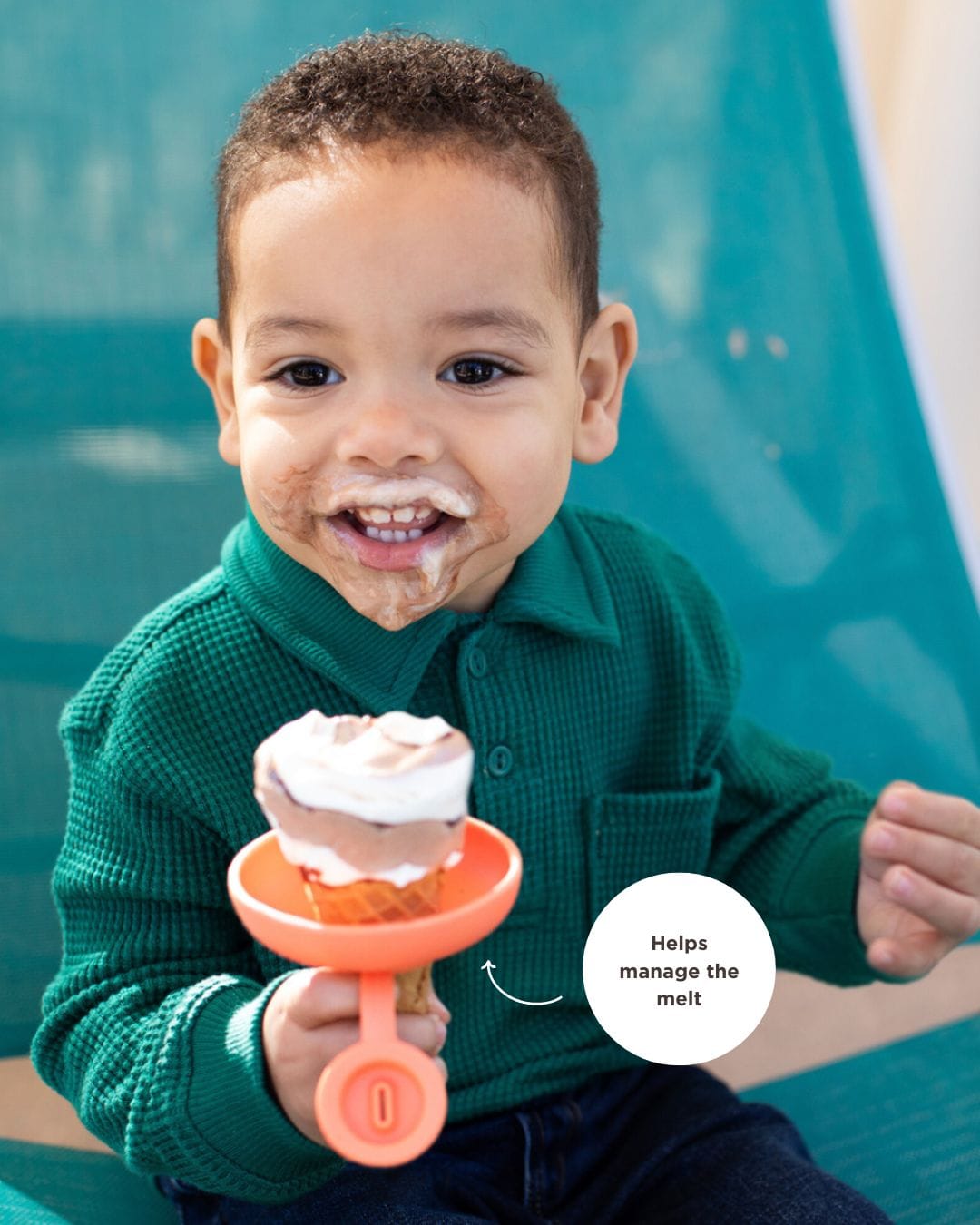 child holding an ice cream cone in a silicone holder to stop dripping