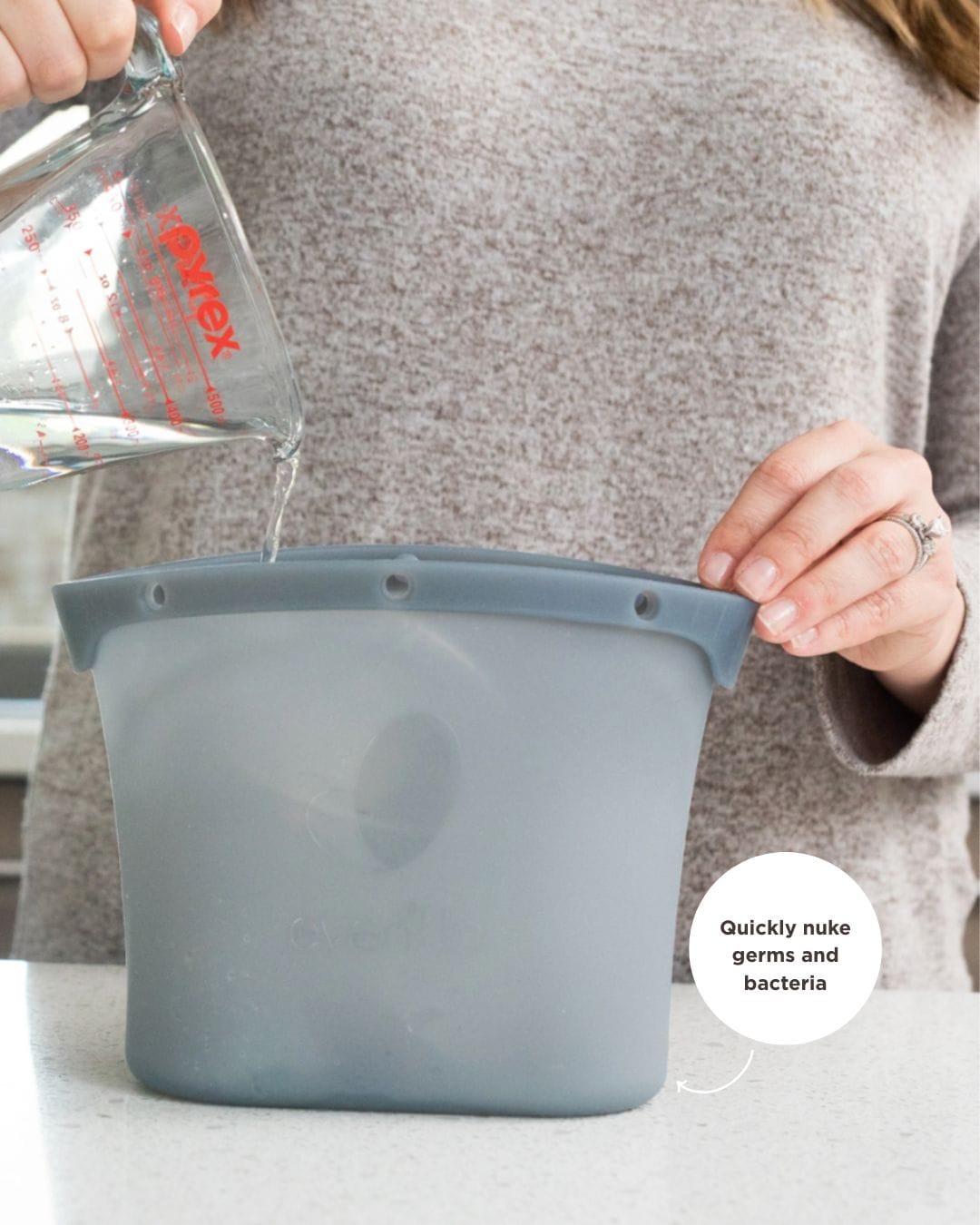 woman pouring water into a silicone microwave sterilizer bag