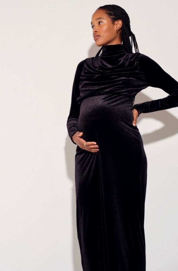 woman wearing black velvet maternity dress from Nuuly