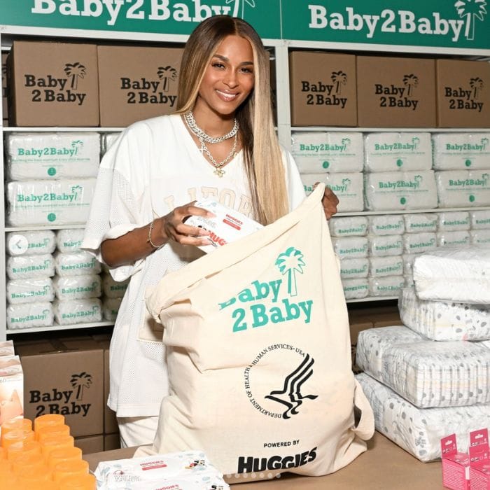 Ciara packinging diapers and wipes into a Baby2Baby donation bag