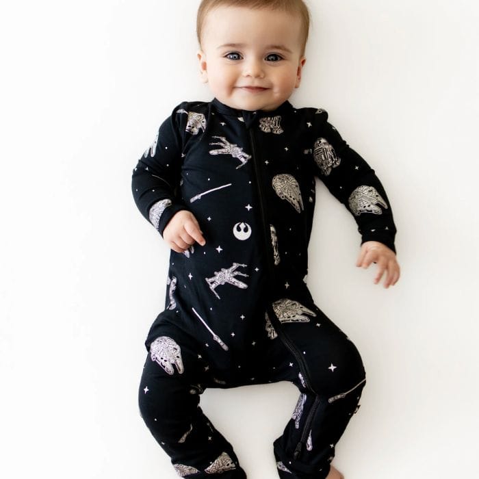 baby in black star wars one peice sleeper pajamas