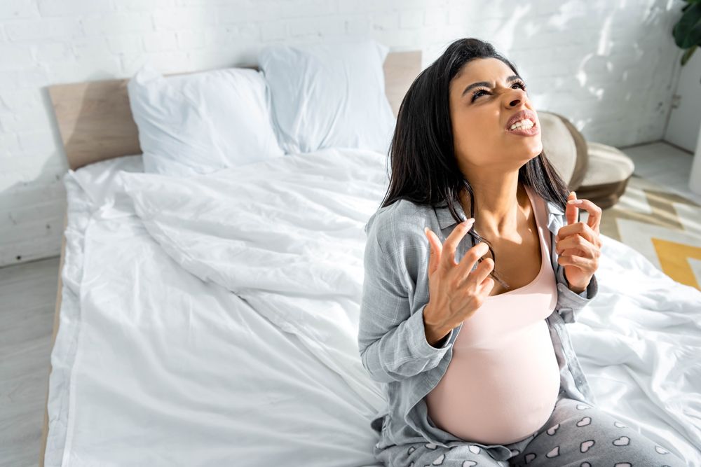 pregnant woman wondering WTF about pregnancy symptoms