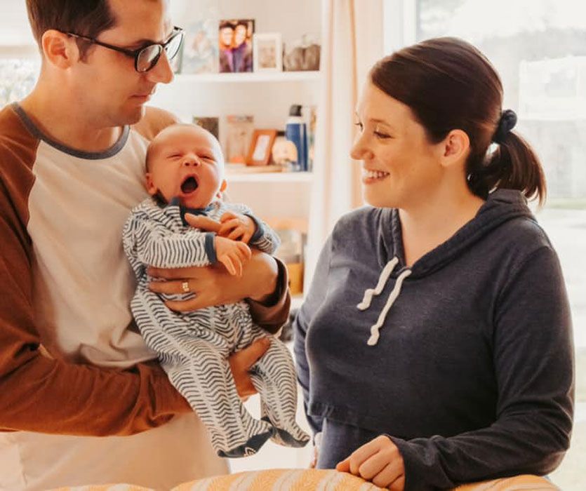 mom and dad with their baby boy who was born during the pandemic