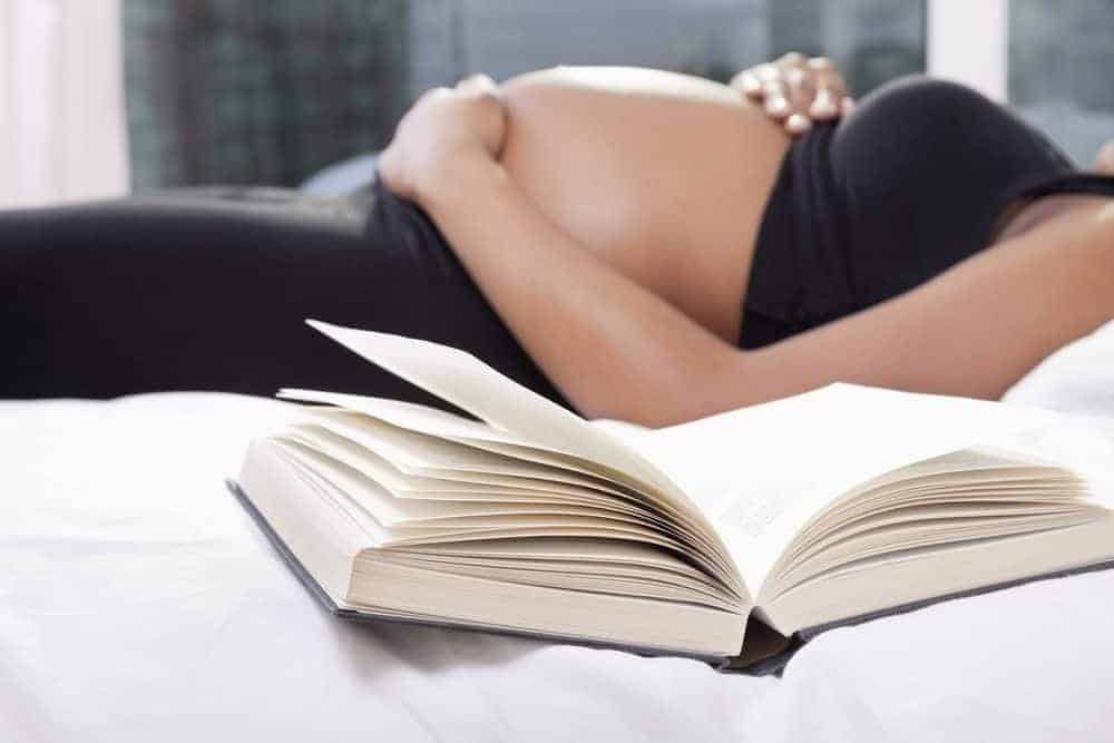 pregnant woman laying in bed on bed rest