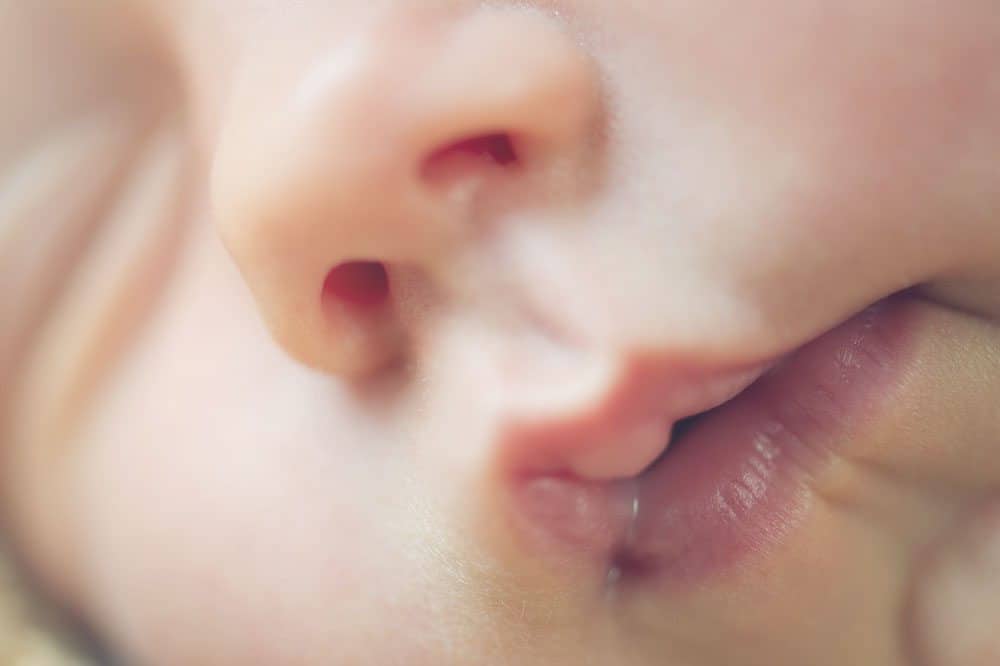 close up of a baby's face in the first 4 months