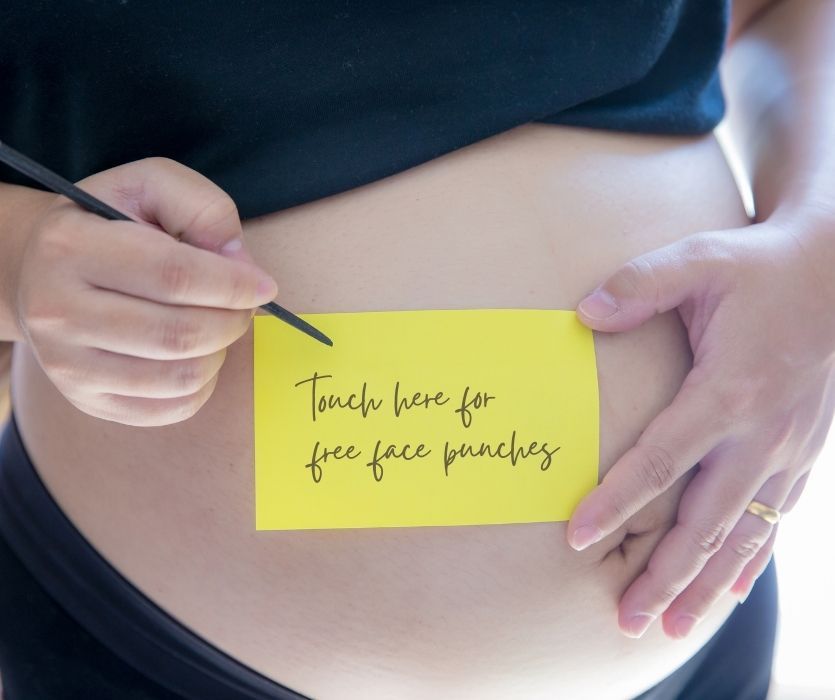 Close up of a pregnant belly with a yellow note that reads: Touch here for free face punches.