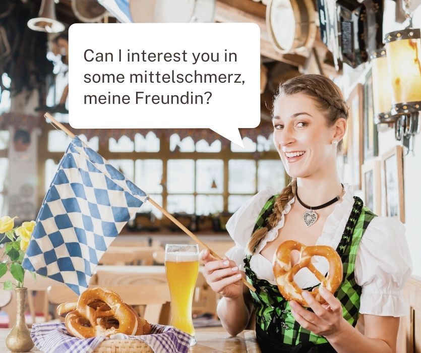 Woman in a dirndl holding a pretzel. Text: Can I interest you in some mittelschmerz, meine Freundin?
