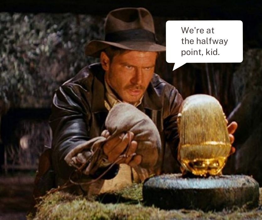 Indiana Jones swaps a bag of sand for a golden idol. Speech bubble: We're at the halfway point, kid.