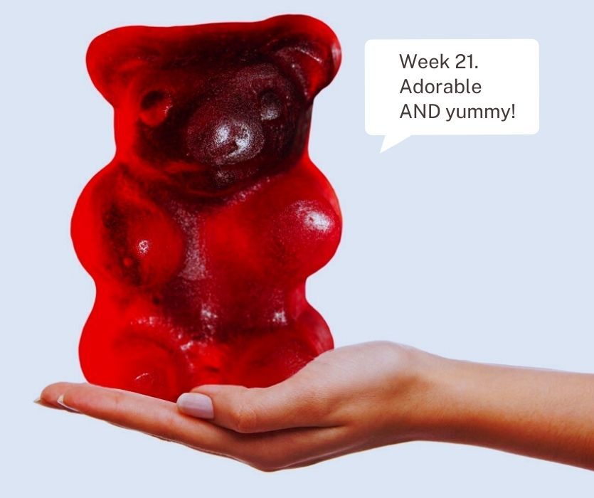 A giant red gummy bear held in a person's palm. Text: Week 21. Adorable AND yummy!