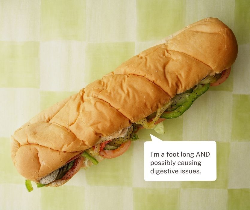 A foot-long sub sandwich on a checkered background with a speech bubble about being the size of a 24-week-old fetus.