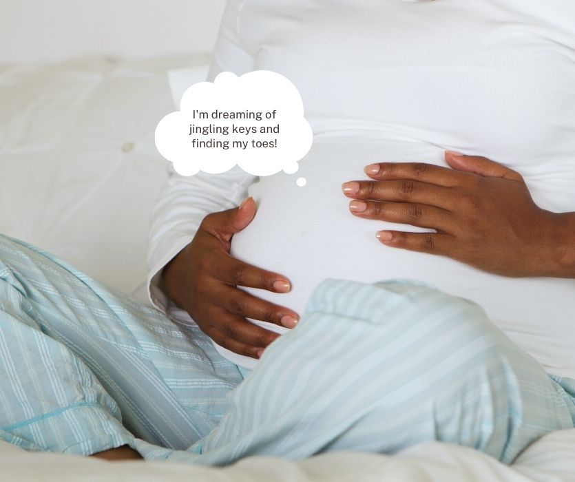 A pregnant woman cradles her belly with a thought bubble saying, I'm dreaming of jingling keys and finding my toes!