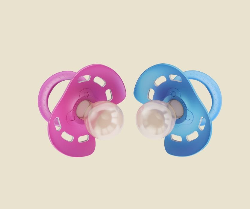 Pink and blue baby pacifiers on a neutral background evoke old wives' tales and gender prediction, with a playful boy-or-girl roundup comparison.