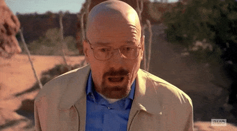 Walter White from Breaking Bad collapses to the ground in a desert with a shocked, devastated expression.
